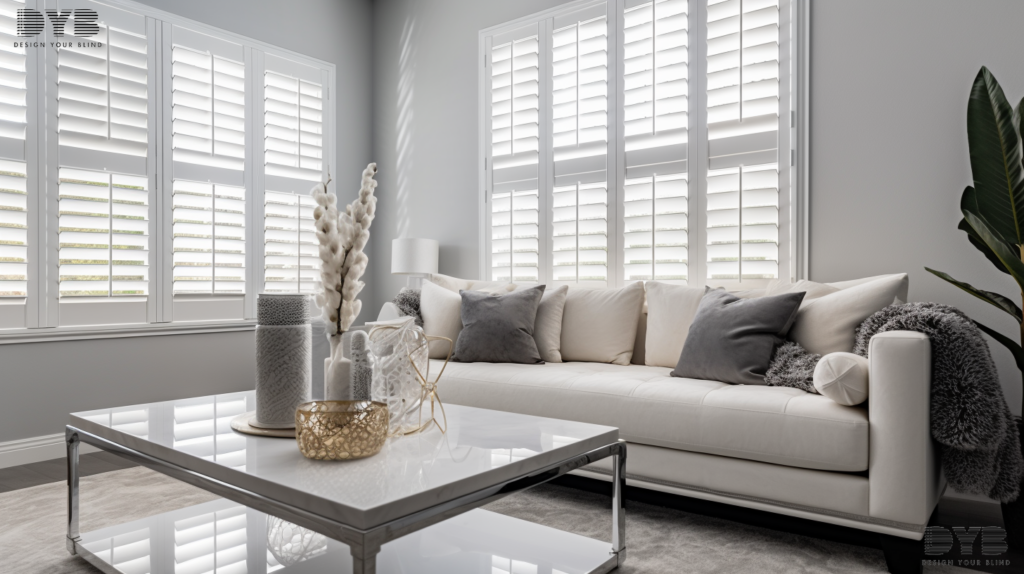Close-up of white plantation shutters in a Boca Raton home, with a white sofa and coffee table in the background.