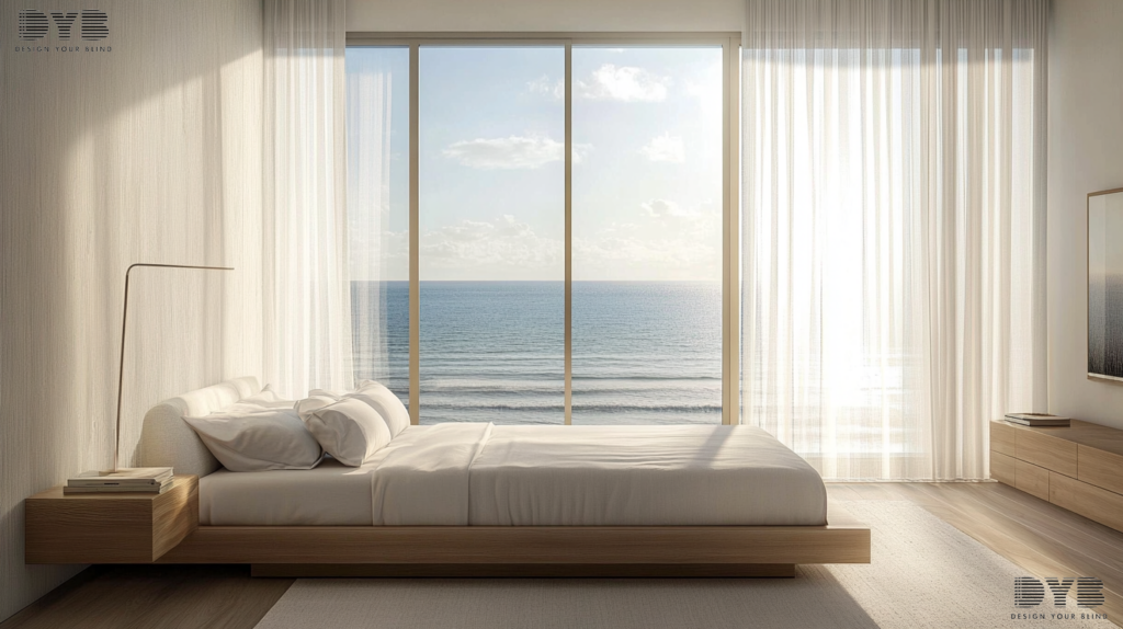 A Minimalist Bedroom in Lighthouse Point, FL, featuring Sheer Curtains on a large window overlooking the ocean. The room is designed with sleek furniture from Crate & Barrel, including a platform bed with a white linen duvet, a simple nightstand, and a floor lamp. The Sheer Curtains are fully closed, creating a serene and peaceful atmosphere, allowing for a soft, diffused light to filter through. The curtains are the focal point of the image.
