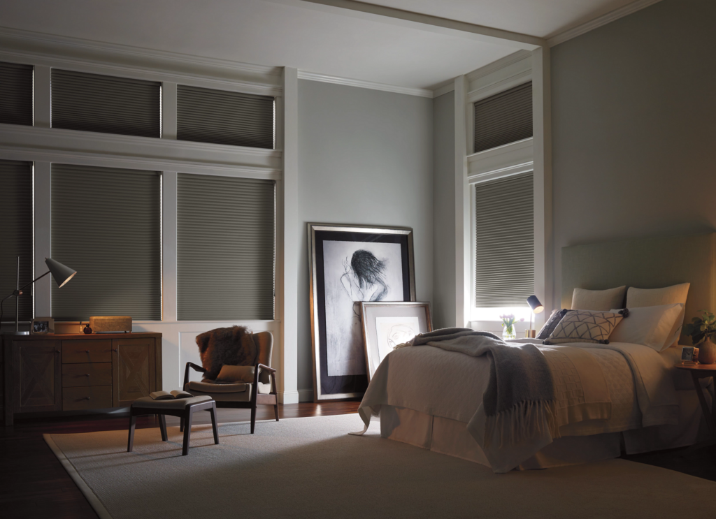 Experience unparalleled light control with motorized blackout honeycomb shades in this Boca Raton bedroom.